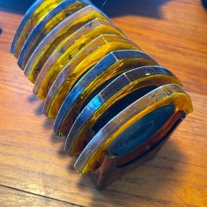 Bakelite coaster set. Amber in color  nice condition for its age. Mid century